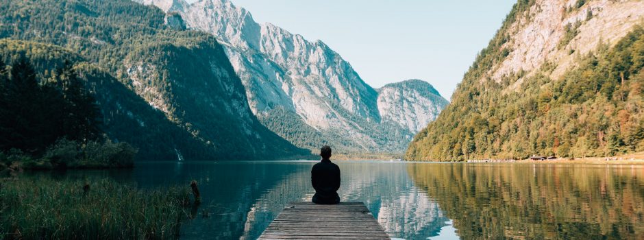 man on end of dock looking at view