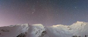 snowy mountains and night time stars